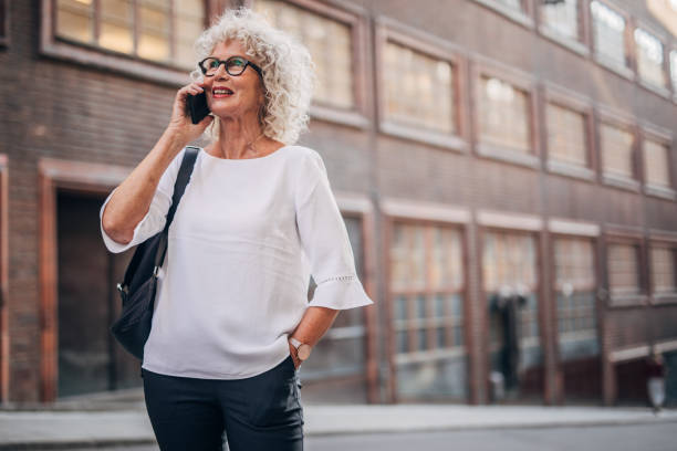 istock Charming woman talking on mobile on the street 1177033573