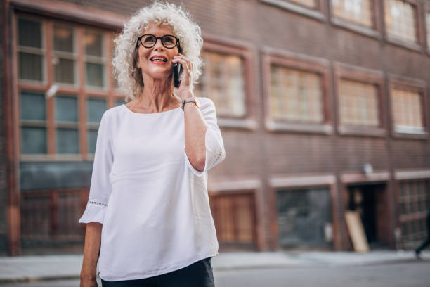 istock Woman talking on mobile on the street 1177033581