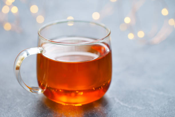 istock Tea in glass cup with light garland. Grey background. Copy space. 1177033620