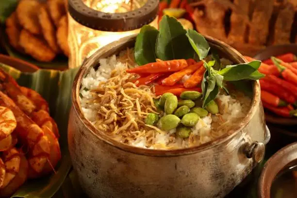 Nasi Liwet Sunda, the aromatic and seasoned rice dish from Sundanese cuisine in West Java. The rice is cooked with spices, salted anchovies and broad beans in a special kettle cooking pot for cooking this rice.