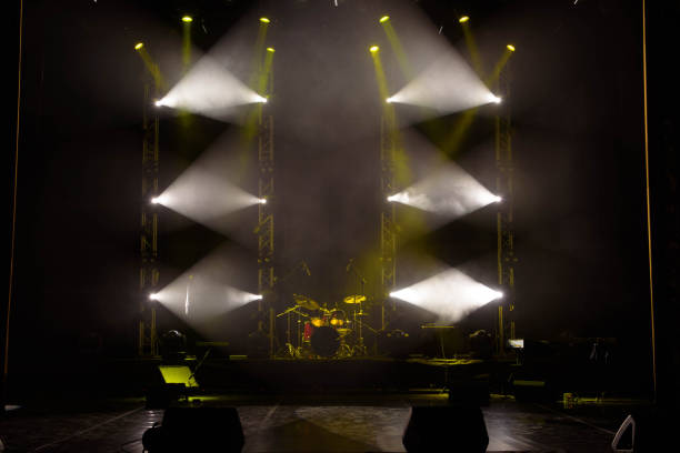 istock The light of searchlights in smoke on stage. 1177033754