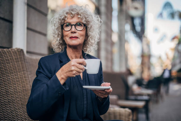 istock Charming lady drinking coffee in cafe outdoors 1177034106