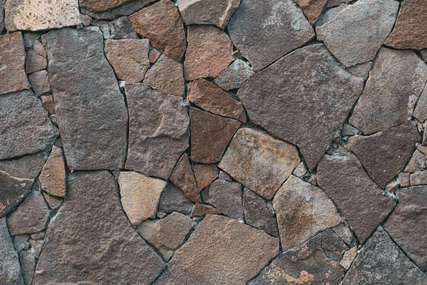 istock Abstract stone wall texture. Gray rock background. Backdrop. Retro style. Textured surface. Facade, building details. Mosaic of bricks. Grey grunge surface. Natural pattern. 1177034874