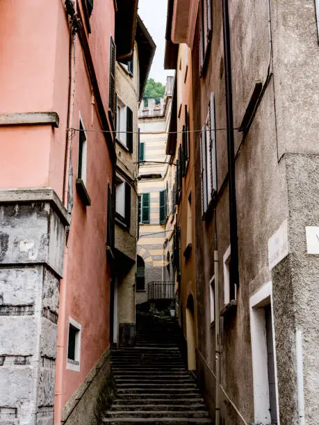 A laneway through a small town near lake Como with stone architectural features.