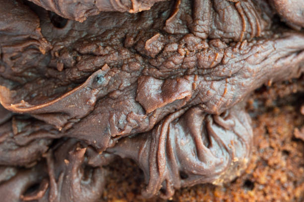 istock Chocolate frosting on chocolate cake. Close up of icing. 1177039184