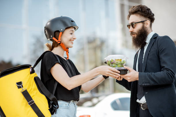 istock Female courier delivering food to an office worker 1177039509