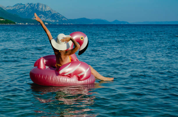 istock Woman with white straw hat on Flamingo float 1177039535