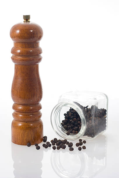 istock Pepper grinder and black peppercorns. 117704023