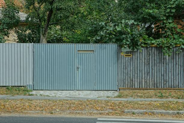 istock gray metal gate with green vegetation 1177044566