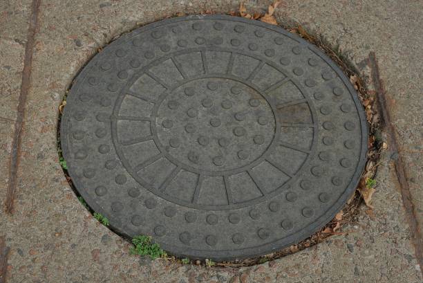 istock one gray round iron manhole laying on the road 1177045121