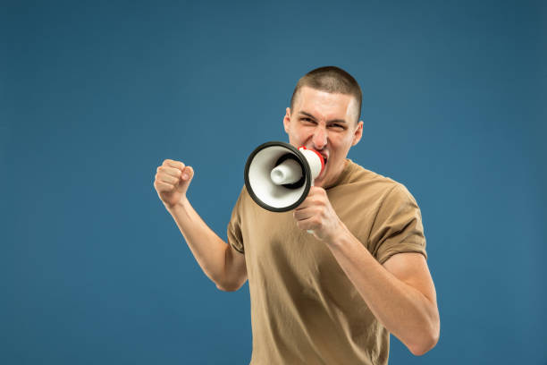 istock Caucasian young man's half-length portrait on blue background 1177045386