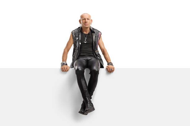 istock Middle aged punk in leather clothes sitting on a panel 1177047641