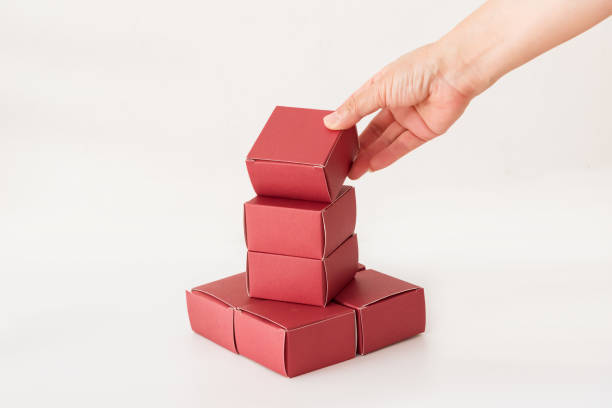 istock Hand holding red small carton on white background 1177049135