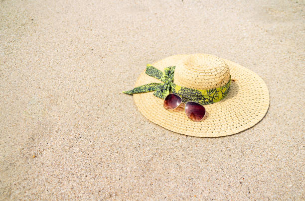 istock Hat and sunglasses over beach sand. Vacation concept 1177051349