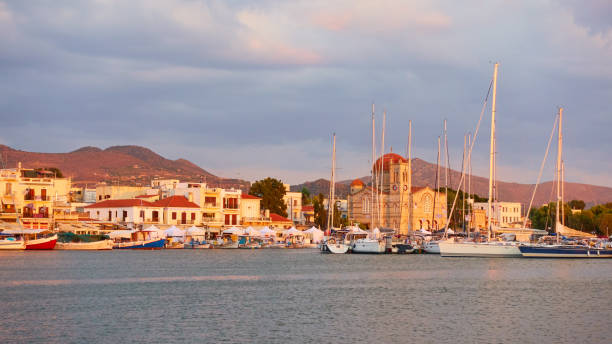 Panoramic view of port and waterfront in Aegina town at sunset, Saronic Islands, Greece