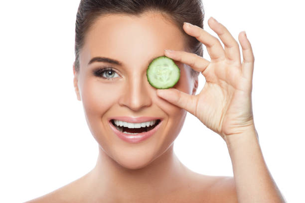 istock Young beautiful woman with cucumber slices 1177054012
