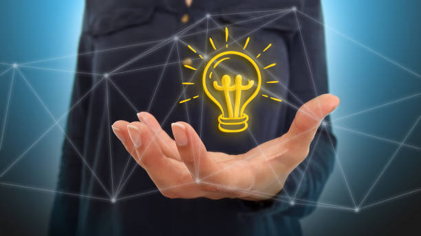 istock Businesswoman on blurred background using light bulb over network connections 1177054617
