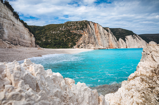 Idyllic turquoise Fteri beach in Kefalonia island, Greece. View through the rocks.