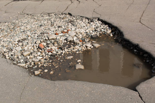 istock Bad roads. Hole in the asphalt 1177060338