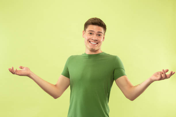 istock Caucasian young man's half-length portrait on green background 1177062257