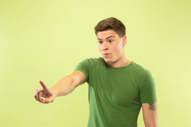 istock Caucasian young man's half-length portrait on green background 1177062264