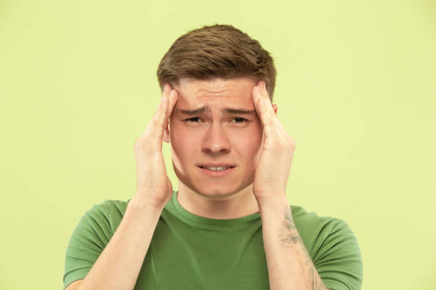 istock Caucasian young man's half-length portrait on green background 1177062890