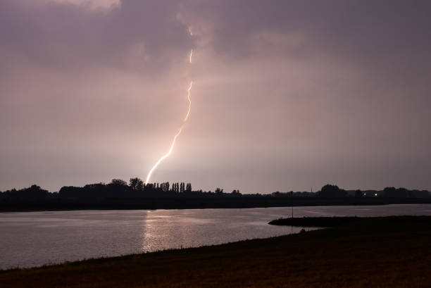 istock Blinding lightning bolt strikes down in a river landscape 1177062966