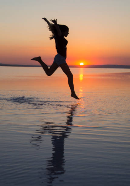 istock Jump over water at sunset 1177063382