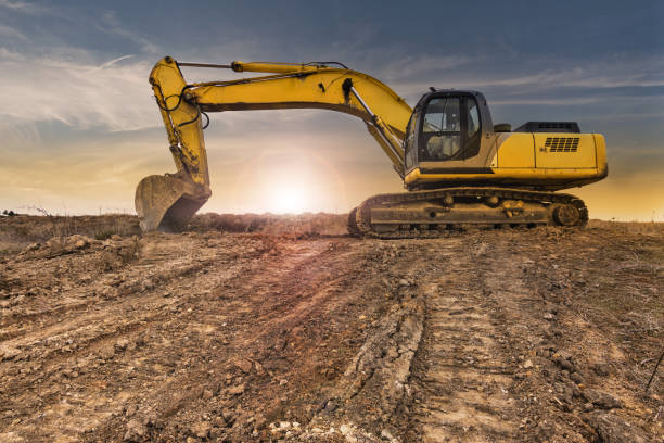 istock Excavator at late afternoon on dry muddy ground 1177065213