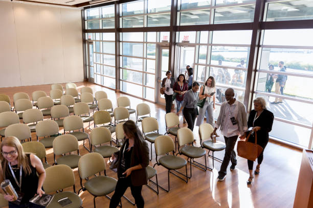 istock High angle view conference attendees filing into auditorium 1177065284