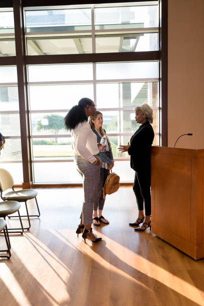 istock Conference speaker meets with women after days events 1177065289