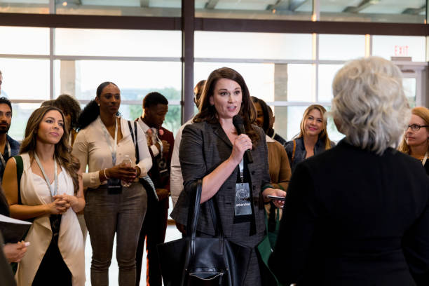 istock Mid adult woman asks unrecognizable speaker question 1177065341