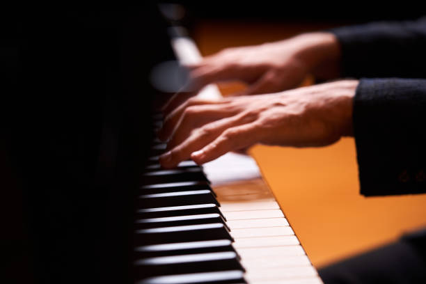 istock Closeup man's hand playing piano. Music performer's hand 1177068444