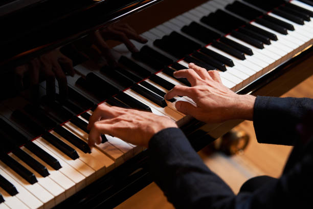 istock Closeup man's hand playing piano. Music performer's hand 1177069032