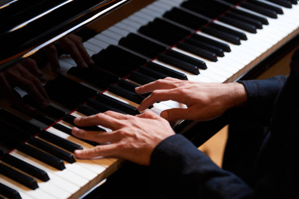 istock Closeup man's hand playing piano. Music performer's hand 1177069036