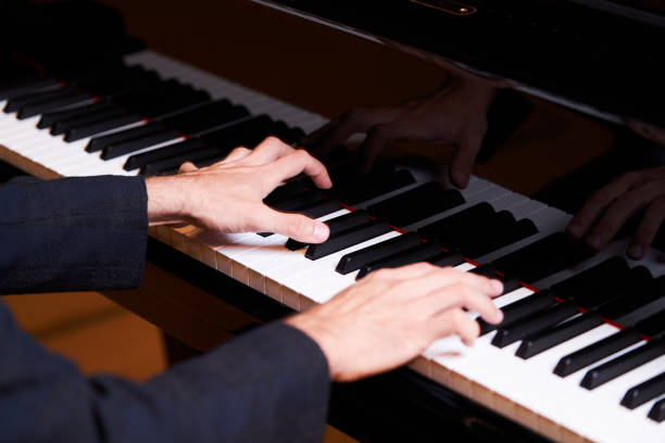 istock Closeup man's hand playing piano. Music performer's hand 1177069040