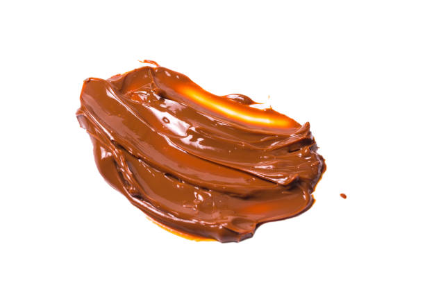 istock Melted tasty caramel splashes isolated on white background. 1177069250