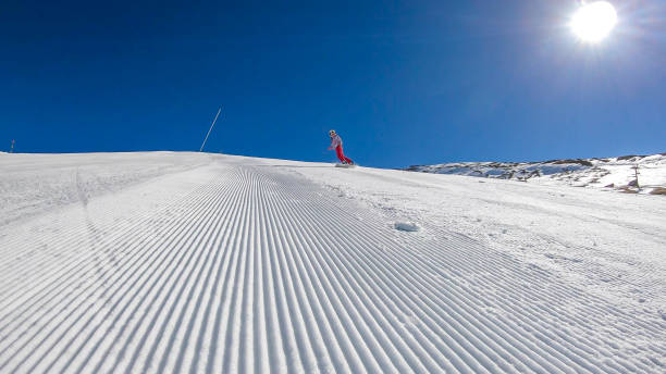 istock Heiligenblut - A snowboarder going down the slope 1177072998