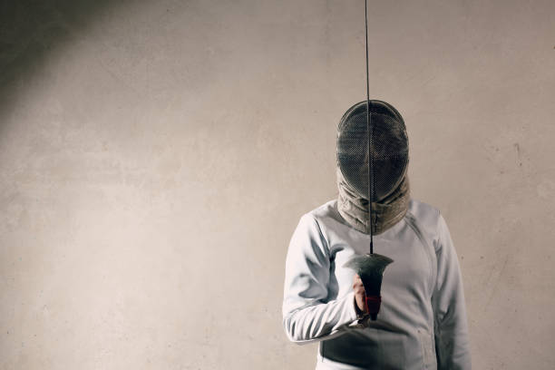 istock Fencer woman with fencing sword. 1177076161