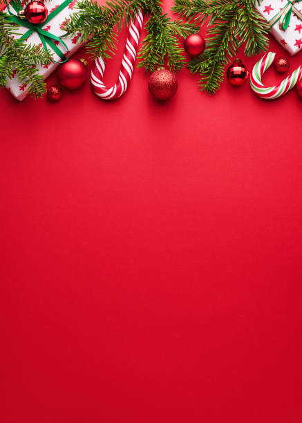 Red background for Merry Christmas and happy New Year design Red background. Copy space for Christmas creep. Border of fir branches, gifts, Christmas balls and candy cane. Happy Holidays design sphere photos stock pictures, royalty-free photos & images
