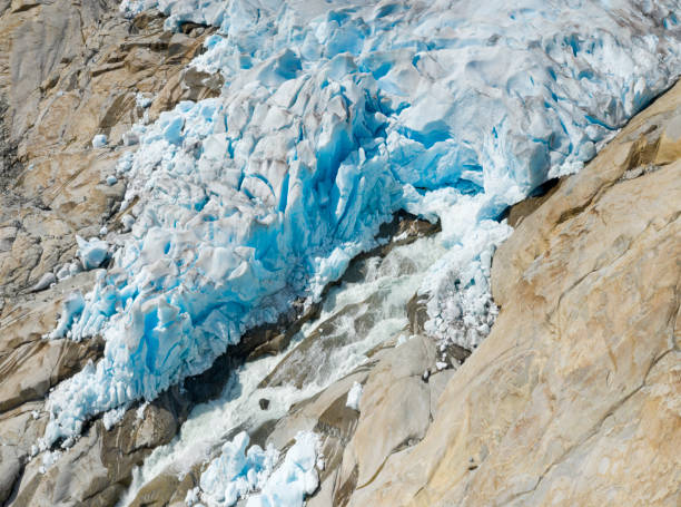 Aerial panorama of the million year old Nigardsbreen Glacier Ice melting, Jostedalsbreen National Park, Norway. You can see the blue ice at the bottom melting. Converted from RAW.