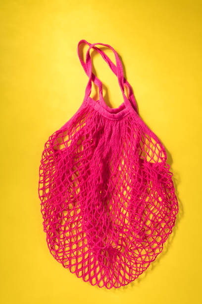 istock Reusable shopping mesh fuchsia bag on a yellow background. Zero waste, plastic free concept,eco frendly. 1177082015