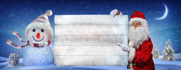 Happy santa claus pointing on blank advertisement banner with copy space. Christmas theme, sales - Image
