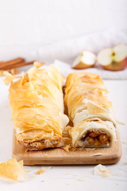 istock Apple strudel on white table. Homemade pie with apples; walnuts and cinnamon. Copy space. 1177085812