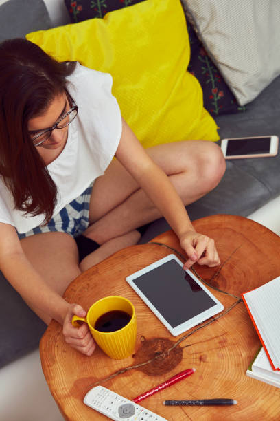 istock Cute girl using notebook and drink coffee while sitting at home. 1177087049
