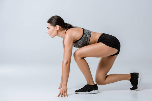 istock side view of brunette sportswoman training on grey 1177087510