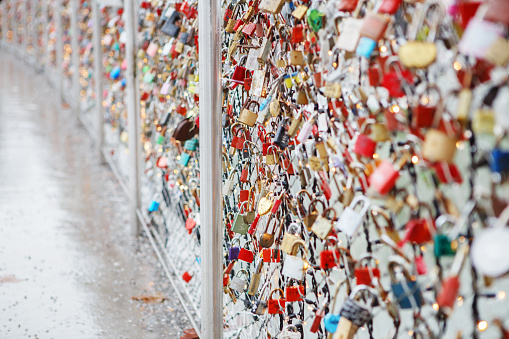 Closeup of love lockers at famous bridge Makartsteg in Salzburg, Austria. Padlocks of love on a bridge, the Makartsteg