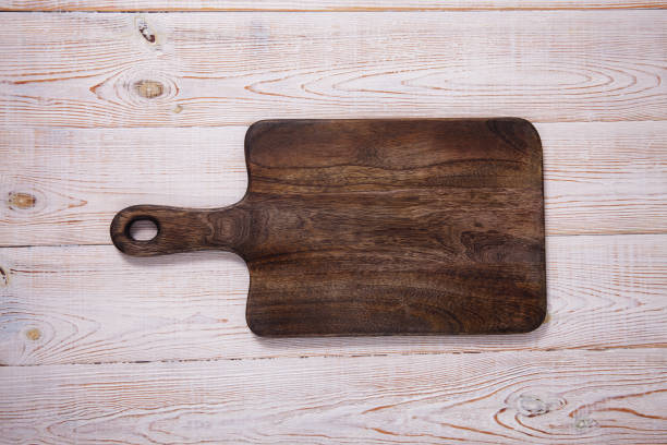 istock Cutting board on the wooden background. Top view. 1177088445
