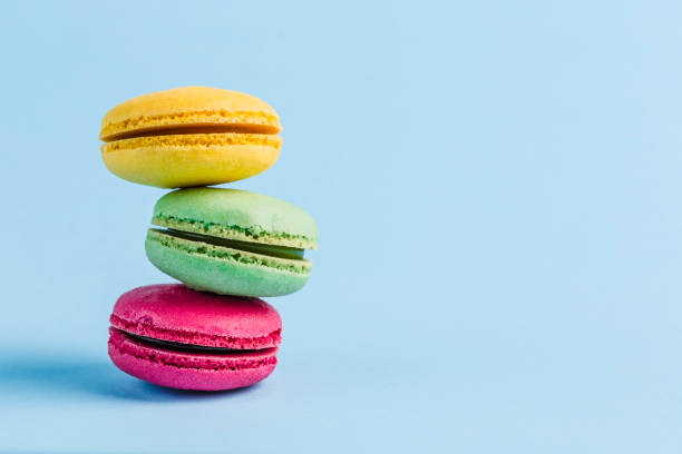 istock Colorful macaroons on a blue background, close-up, Flatley with copy space 1177088651