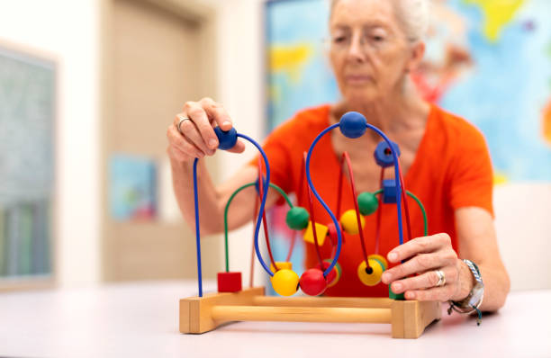 Old Woman make exercise why she is protected Alzheimer's disease stock photo